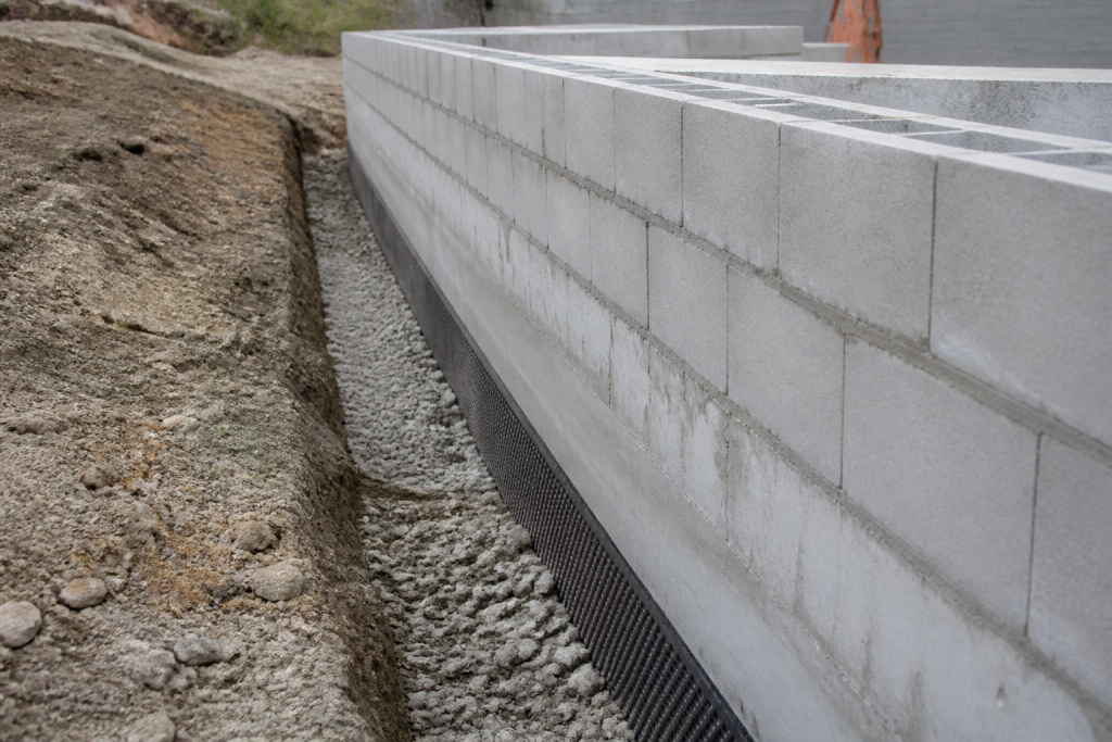 Mur beton blocs gris drainage gravier fondation